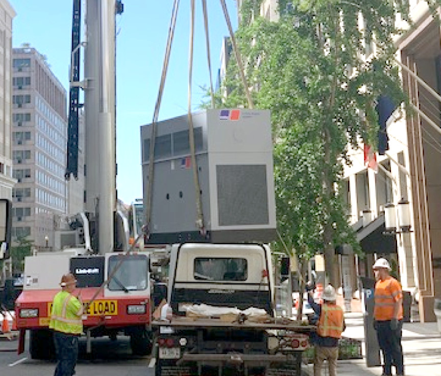 HVAC equipment being lifted for installation.