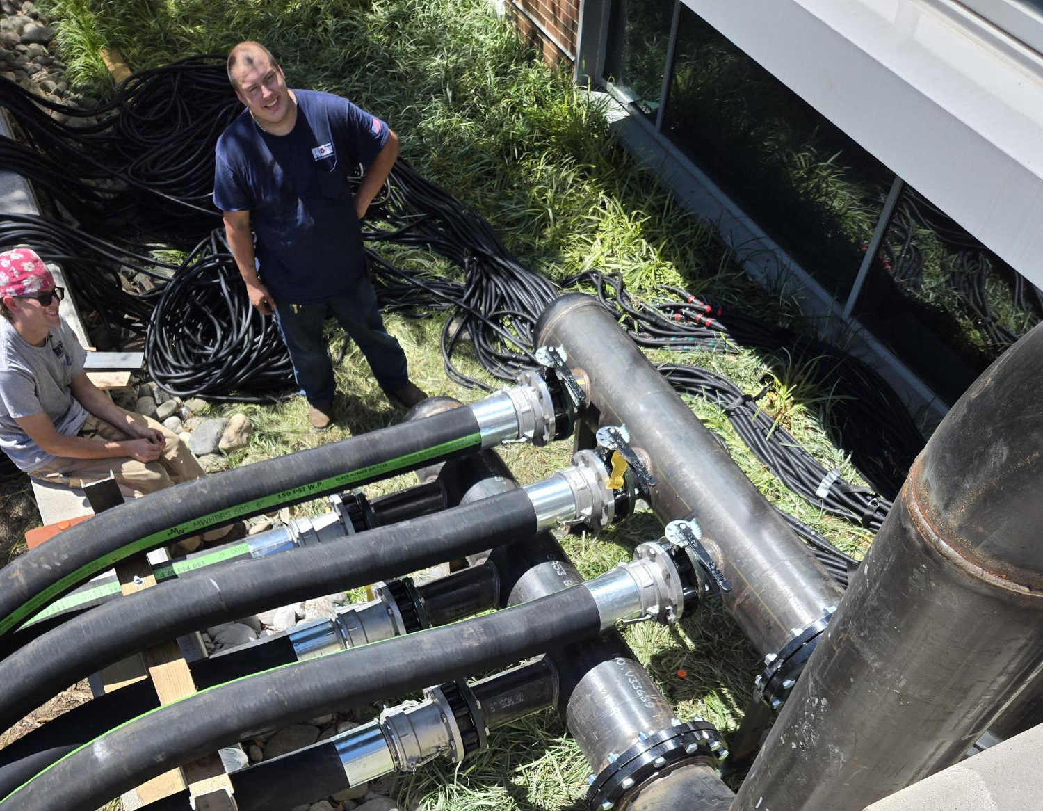 ACI technicians working outdoors on large temporary chiller piping connections, demonstrating the team’s rapid mechanical installation and field coordination during an emergency cooling project